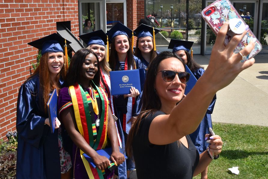 Students and staff pose for pictures at the 2018 commencement ceremony