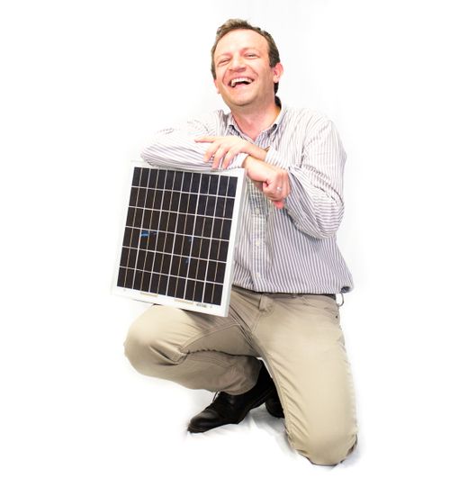 Dr. Kenan Hatipoglu laughs as he holds a solar panel