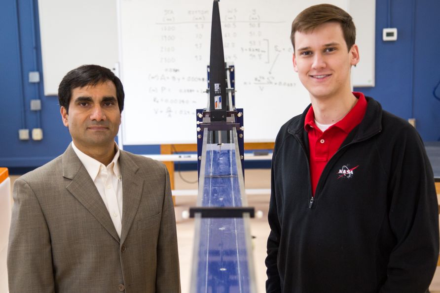 Dr. Yogendra Pants (left) stands in an engineering lab with Austen Robinson (right).