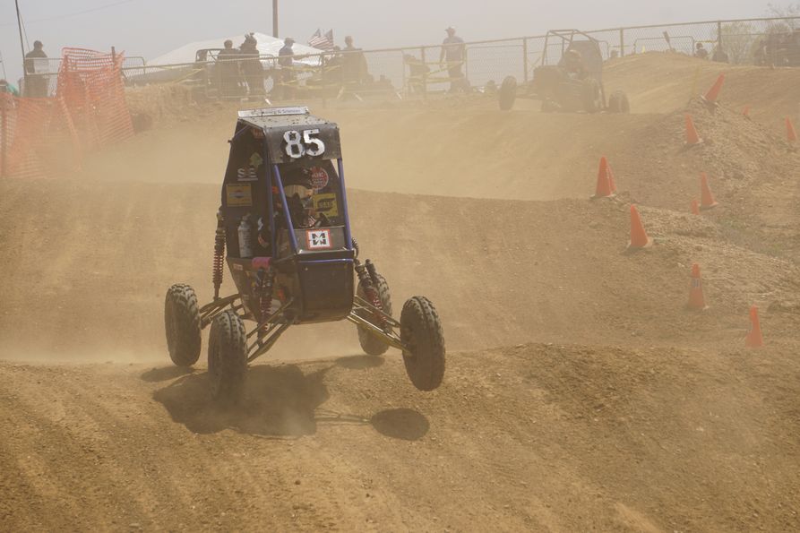 The SAE Baja buggy catches air during a race.