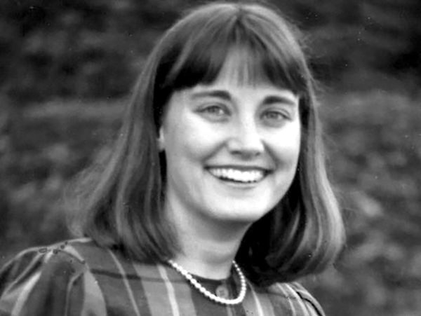 A black and white photo of Kathleen Jacobs, smiling at the camera.